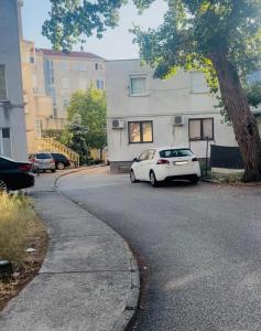 a white car parked on the side of a street at Tinela in Mostar