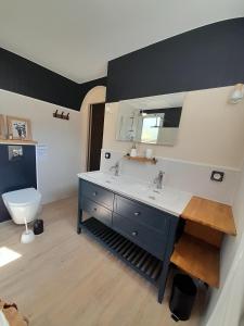 a bathroom with a sink and a toilet at Le clos de Tallann in Guénin +7 photos