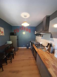 a kitchen with a stove and a counter top at Le clos de Tallann in Guénin