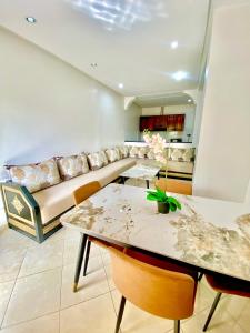 a living room with a couch and a table at Agadir City Appartement in Agadir
