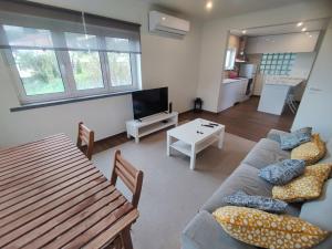 a living room with a couch and a table at Cascais, Family retreat in a 2-bedroom apartment in Alcabideche