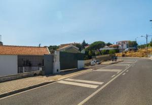 an empty street in a town with houses at Cascais, Family retreat in a 2-bedroom apartment in Alcabideche