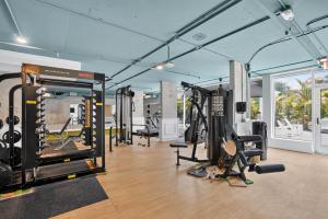 a gym with several treadmills and exercise equipment at Kompose Boutique Hotel Sarasota in Sarasota