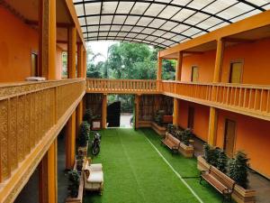 an empty courtyard of a building with benches at P'almshore Ecr' Resort in Mahabalipuram