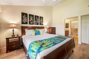 a bedroom with a large bed and a bathroom at WAILEA ELUA, #1104 in Wailea