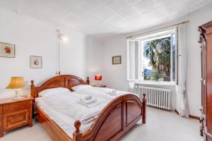a bedroom with a large bed and a window at Casa Naima: Family House | Terrace & Peaceful Location - Happy Rentals in Breno