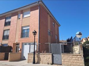 a brick building with a street light in front of it at Oasis Segovia in San Cristóbal de Segovia