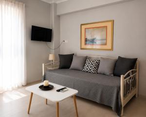a living room with a couch and a table at Alice House 1 in Amarynthos