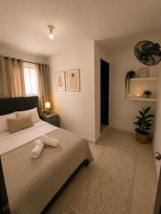 a bedroom with a bed with two towels on it at Ortega La 33 Hotel y Spa in Medellín