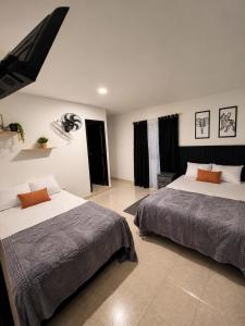 a bedroom with two beds in a room at Ortega La 33 Hotel y Spa in Medellín