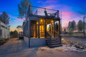 a house with a balcony with a bench on it at Village Camp Flagstaff in Bellemont +21 photos