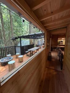 a view of the deck of a cabin with a table and benches at Kozakura Cottage II in Hamamatsu
