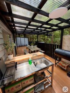 a patio with a sink and a table on a deck at Kozakura Cottage II in Hamamatsu