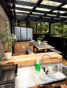 a patio with a sink and a table on a deck at Kozakura Cottage II in Hamamatsu +17 photos