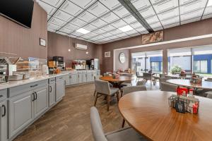 a kitchen with a table and chairs and a dining room at Red Lion Inn & Suites Kansas City in Kansas City