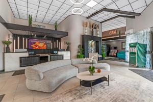a living room with a couch and a table at Red Lion Inn & Suites Kansas City in Kansas City