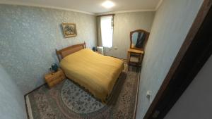 a small bedroom with a bed and a mirror at Zartak cottage in Dilijan