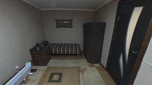 a bedroom with a bed and a dresser in a room at Zartak cottage in Dilijan