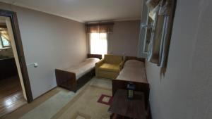 a small living room with a couch and a table at Zartak cottage in Dilijan