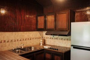 a kitchen with a sink and a refrigerator at Naranjito River Retreat Events & Groups Sleeps 13 in Naranjito +31 photos