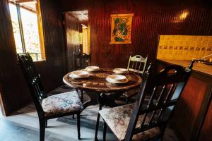 a dining room with a table and chairs and a table and chairs at Naranjito River Retreat Events & Groups Sleeps 13 in Naranjito