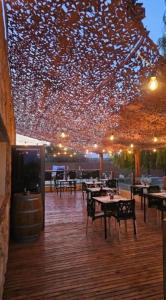 a restaurant with tables and chairs and a lot of lights at Rincon del Malbec 3 in Ciudad Lujan de Cuyo