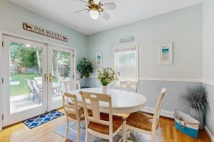 a dining room with a white table and chairs at Sunny Side Up in Oak Bluffs