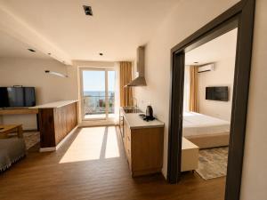a hotel room with a bedroom with a bed and a window at Donna in Ulcinj