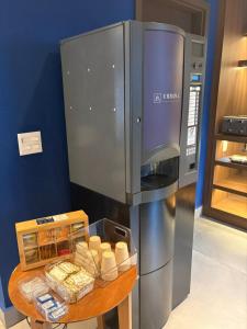 a kitchen with a refrigerator and a table with food at Urban L in São Paulo