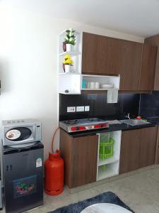 a small kitchen with a stove and a sink at Le Kirstel Suites in Kiambu