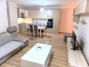a living room with a couch and a table at Astir Apartments in Tirana