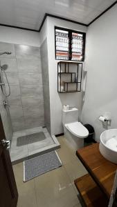 a bathroom with a shower and a toilet and a sink at Mi Barrio in Cartago +26 photos