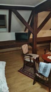 a room with two chairs and a desk with a laptop at Vila Olga in Sombor