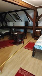 a living room with a table and chairs and a couch at Vila Olga in Sombor