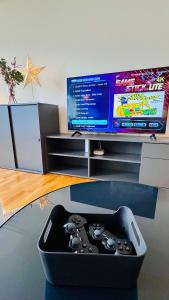 a video game controller sitting on a table in front of a tv at Mountainview Apartment - Central - Family - Hiking - Lake and Mountains in Schwyz