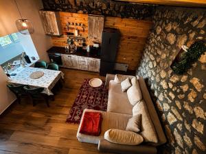 a living room with a couch and a table at Arhetip, Kikina Villa in Njegovuđa