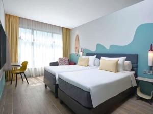 a hotel room with two beds and a desk at ibis Styles Vung Tau in Vung Tau +73 photos