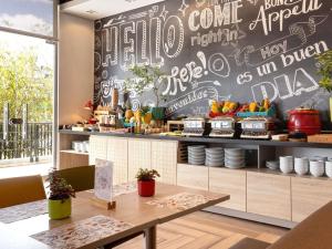 a restaurant with a table and a chalkboard wall at ibis Chia in Chía