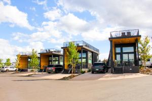 a building with cars parked in a parking lot at Village Camp Flagstaff in Bellemont