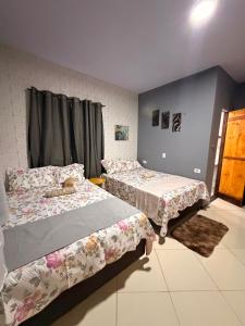 a bedroom with two beds and a window at Casa Dunas Temporada in Barreirinhas