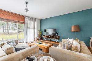 a living room with a couch and a table at Summer Villa in Troia