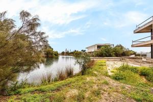 a view of a river with trees and a building at Summer Villa in Troia
