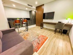 a living room with a couch and a desk at Pak Hospitality in Islamabad