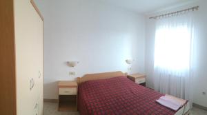 Postel nebo postele na pokoji v ubytování Apartments Bodi