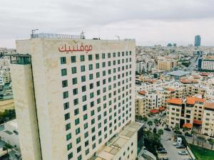 a building with a bulovo sign on top of it at Mövenpick Hotel Amman in Amman