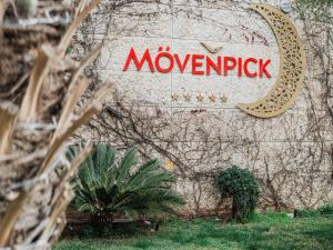 a sign for novemberick on the side of a building at Mövenpick Hotel Amman in Amman