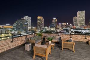 a rooftop with couches and a city skyline at night at King Bed Prime Location Downtown Hotel Suite in New Orleans