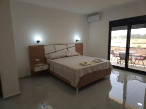 a bedroom with a bed and a table with chairs at Caci Apartments in Gornji Štoj