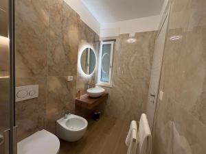 a bathroom with a toilet sink and a mirror at Colombo Boutique Rooms in Tortoreto Lido +28 photos