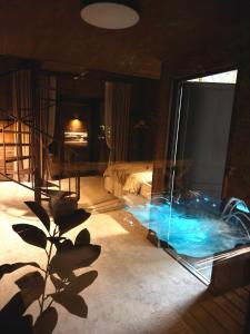 a room with a bed and a large glass window at Royal Ranch Nature Resort in Orhei